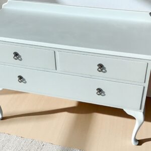 a white dresser with drawers