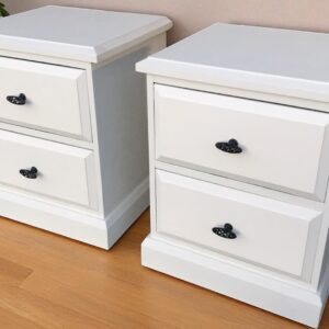 two white nightstands on a wood floor