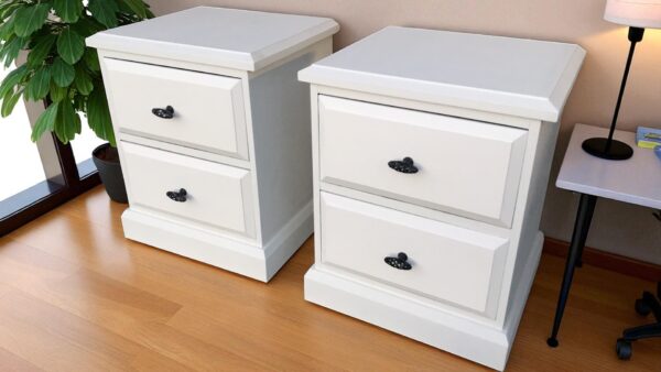 two white nightstands on a wood floor