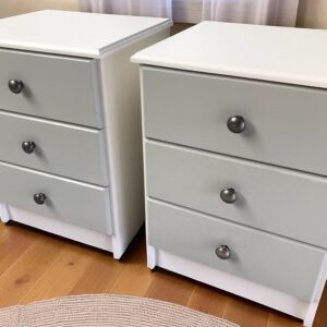 two white drawers on a wood floor